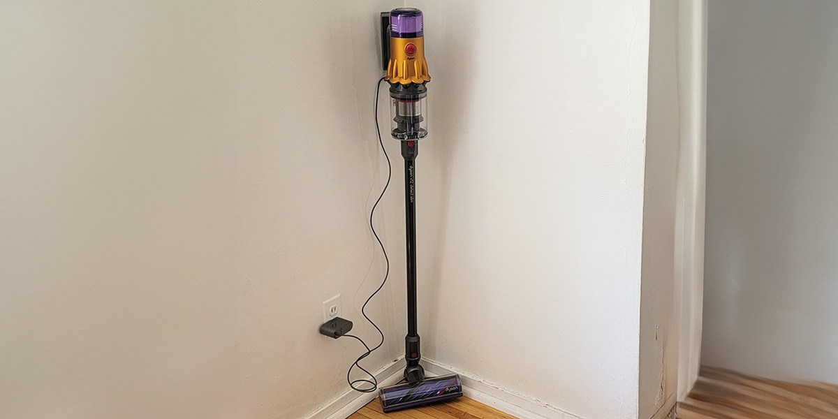 Dyson V12 Detect Slim leaning up against wall